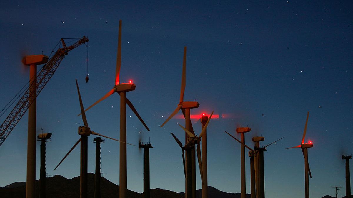a picture of wind mills at night