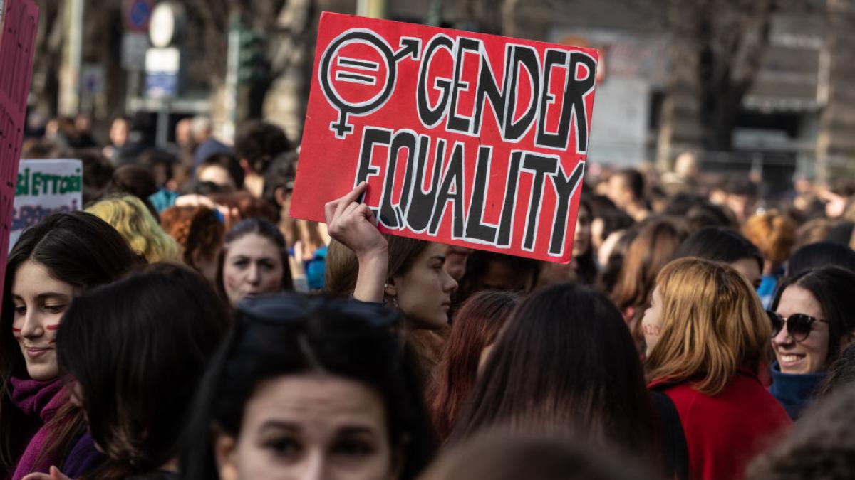 Women in a demonstration holding a placard reading 'Gender Equality'