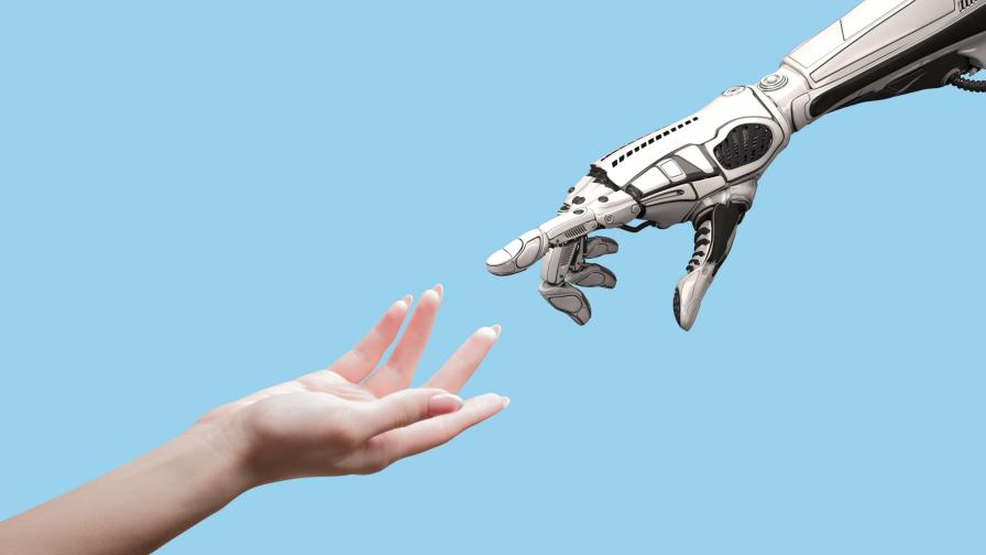 Human arm and robot arm reaching towards each other.