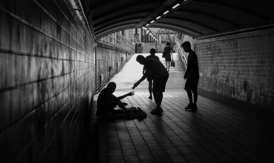 Man in the street being given money (black and white picture)