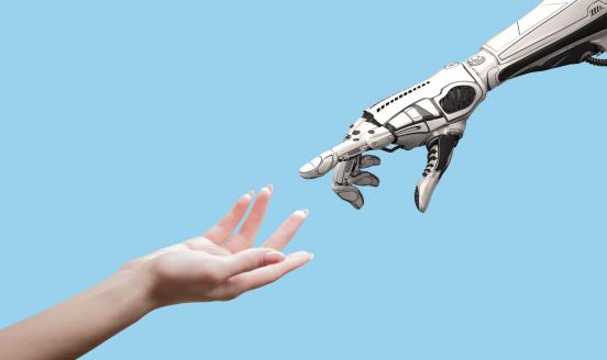 Human arm and robot arm reaching towards each other.