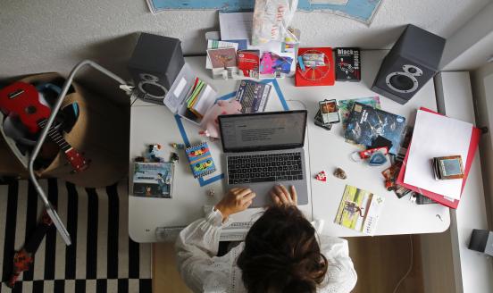 A woman works at an Apple Inc. laptop computer on a desk in a children's bedroom in this arranged photograph taken in Bern, Switzerland, on Saturday, Aug. 22, 2020. 