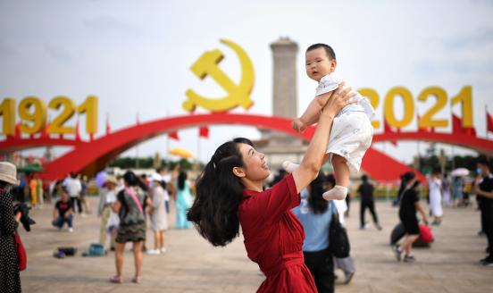 Tourists pose for photos in front of an art installation marking the 100th anniversary of the founding of the Communist Party of China (CPC) at Tiananmen Square on July 2, 2021 in Beijing, China.