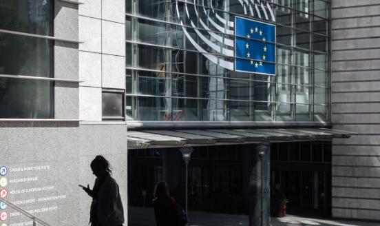 Image of the Spinelli building at the European Parliament in Brussels, as a girl walks past 