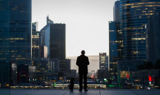 Man in front of buildings