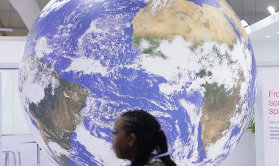 Photo of woman in front of globe