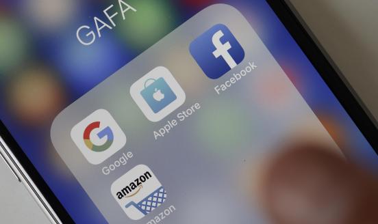 In this photo illustration, logos of the Google, Apple, Facebook, and Amazon applications (GAFA) are displayed on the screen of an Apple iPhone on May 31, 2018 in Paris, France. The acronym GAFA refers to the four most powerful companies in the world of the internet: Google, Apple, Facebook and Amazon. The European Union has decided to better tax the giants of the internet with Brussels proposing to tax 3% of income generated by the data of users of Internet companies. This new tax would bring in 5 billion 