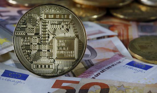  a visual representation of digital cryptocurrency coins sit on display with European banknotes on December 06, 2019 in Paris, France. 