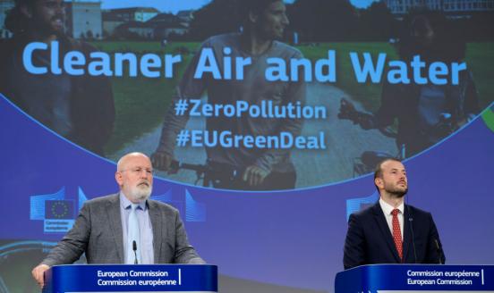 Two politician sitting in front of a screen that says Cleaner Air and Water