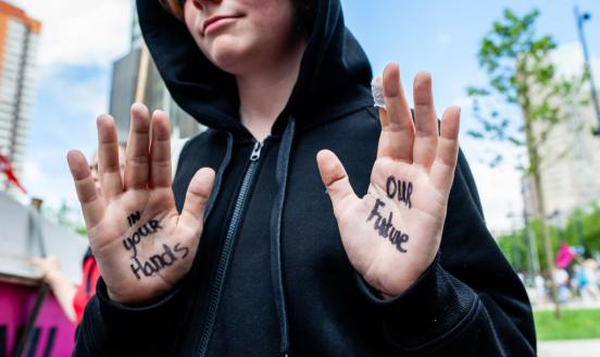 A teenager in a black hoodie