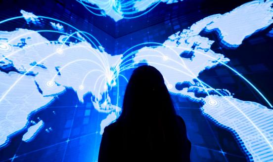 A figure in the shadows looking up at the beautiful ceiling with map of the world projected on it