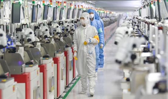 Employees operate machines at a dust-free workshop of a semiconductor factory on March 1, 2023 in Siyang County, Suqian City, Jiangsu Province of China. 