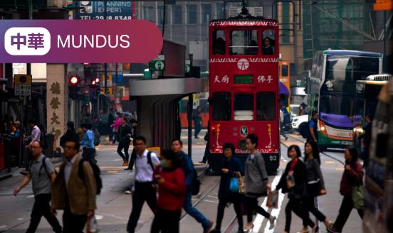 Picture of people crossing the street in front of buses