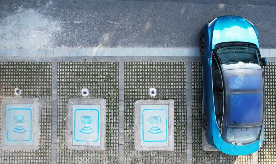 A new energy vehicle with wireless charging capability is charged at a wireless charging facility at the Asian Games Village charging station in Hangzhou, Zhejiang province, China, August 7, 2023. (Photo by Costfoto/NurPhoto via Getty Images)