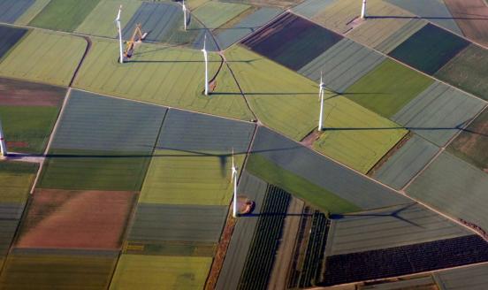 Green field with eolic turbines