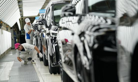 Employees work on the assembly line of Voyah electric vehicles at Dongfeng Motor's Voyah Automobile factory on August 23, 2023 in Wuhan, Hubei Province of China