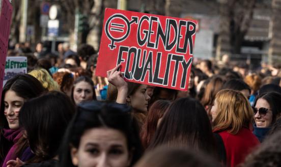 Women in a demonstration holding a placard reading 'Gender Equality' 