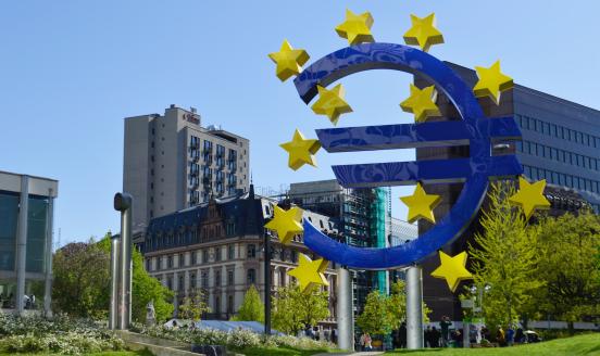 A giant euro sculpture in middle of a city