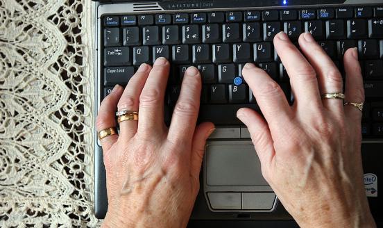 Old woman hands on a keyboard