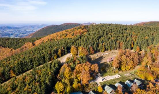 Aerial View of Moravian-Silesian Beskids mountain range as autumn trees shine with colours in Czech Republic on October 20, 2024.