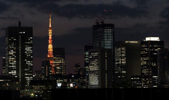 The Tokyo Tower stands illuminated amid commercial and residential buildings at night on April 06, 2020 in Tokyo, Japan. (Photo by Tomohiro Ohsumi/Getty Images)