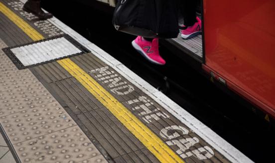 A woman boards an underground train at Bank station as the deadline nears for companies to report their gender pay gap on April 4, 2018 in London, England. 