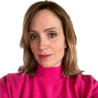 A woman with shoulder-length hair , in a dark-pink turtleneck looking at the camera