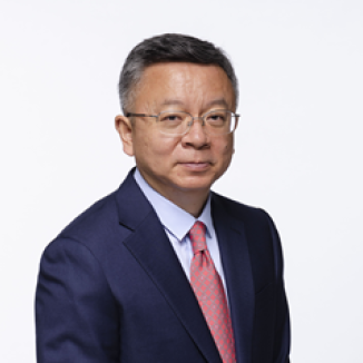 a man in glasses, red tie, blue suit