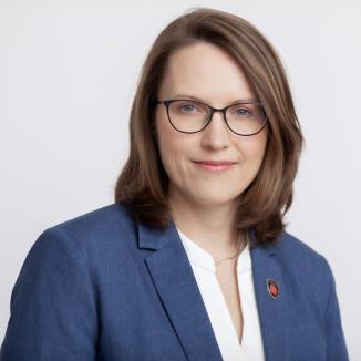 Woman smiling in a navy blue suit