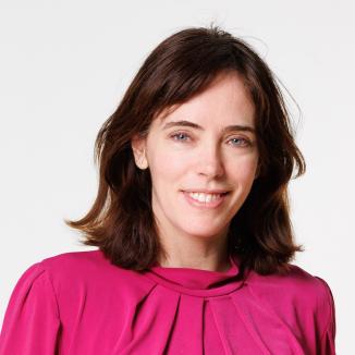 a woman with short brown hair, bright eyes , wearing pink top